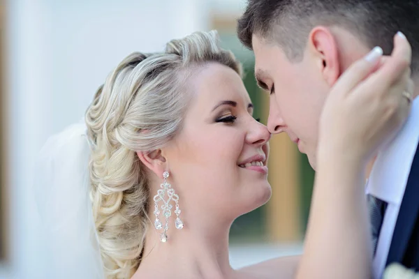 Beautiful bride and groom hugging in park — Stock Photo, Image