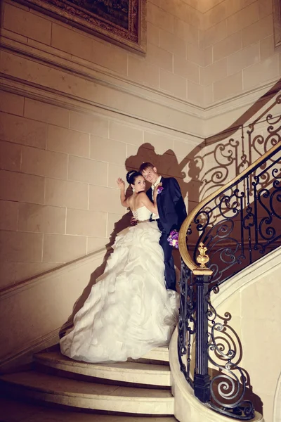 Svatební pár objímání na schodech — Stock fotografie