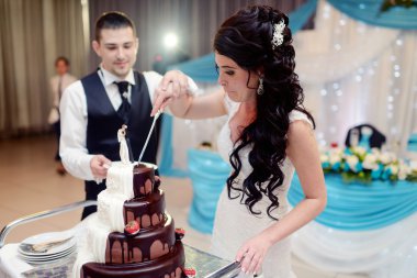 Gelin ve damat düğün pastasını kesiyor