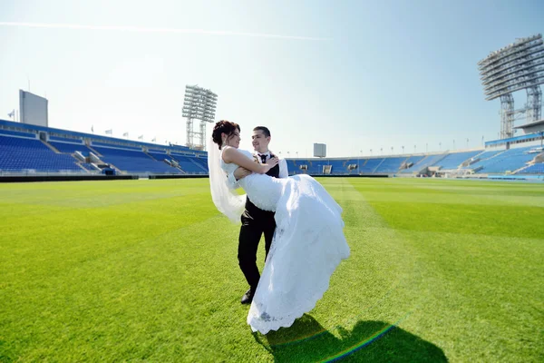 Wedding couple on football stadium