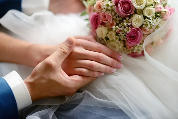 Hochzeitspaar hält Händchen — Stockfoto