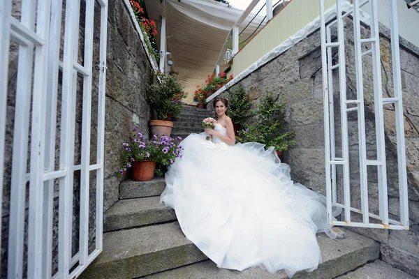 Bella sposa in abito da sposa con bouquet — Foto Stock