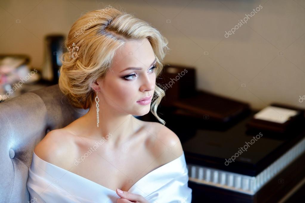 fashionable white gown, beautiful blonde model, bride hairstyle and makeup  concept - closeup young romantic lady in wedding festive dress standing  indoors on light background, pretty woman posing Stock Photo | Adobe Stock