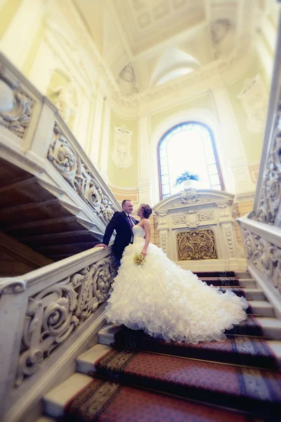 Beautiful wedding couple hugging on stairs — Stock Photo, Image