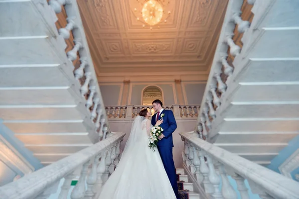 Hochzeitspaar umarmt sich auf Treppe — Stockfoto