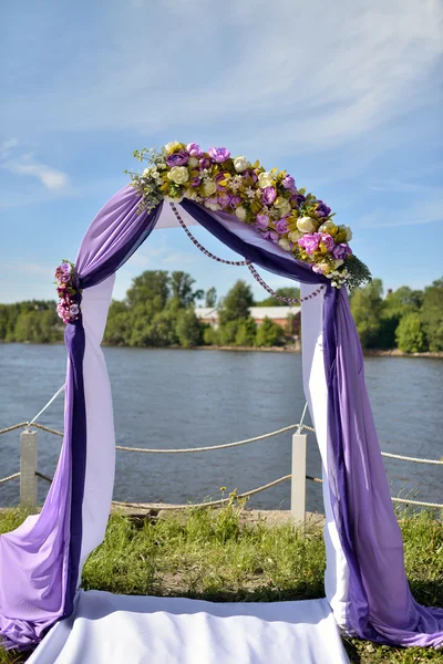 purple wedding arch with flowers
