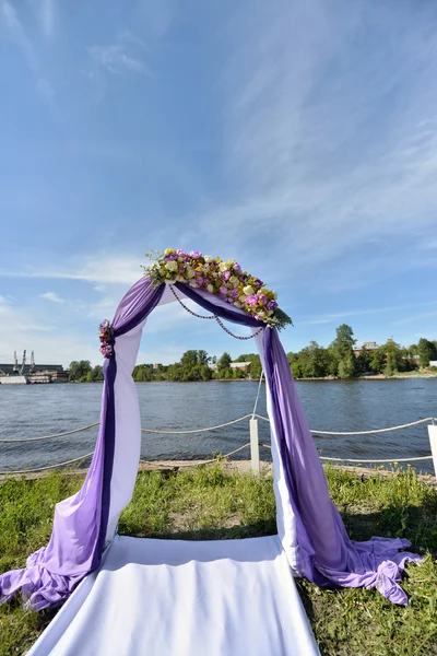 purple wedding arch with flowers