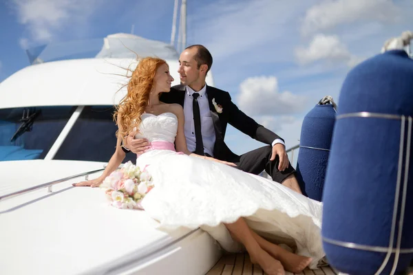 Wedding couple hugging on yacht