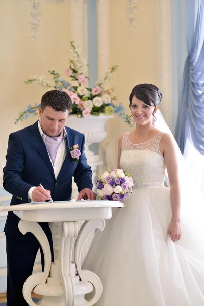 Beauty bride and groom registering marriage — Stock Photo, Image