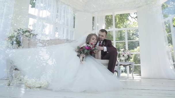 Bride and groom hugging indoors — Stock Video