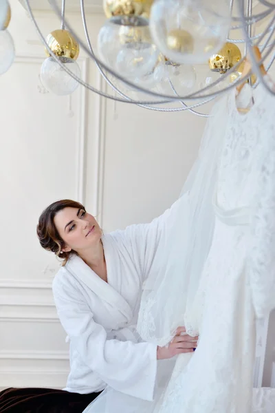 Bride watching wedding dress — Stock Photo, Image