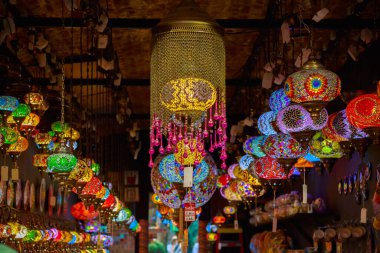 Turkish or Moroccan glass tea light hanging lanterns on display at Camden Market in London, England clipart