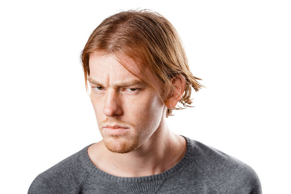 Male portrait of a fair-haired man of European appearance, on a white background. Emotions. Pensive man. Decide. Idea.