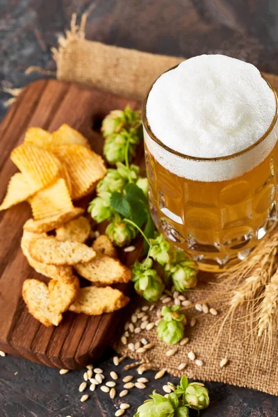 Mug and bottle of beer with green hops, wheat ears and grains on white background. Unfiltered beer. Alcoholic beverages. Hop.