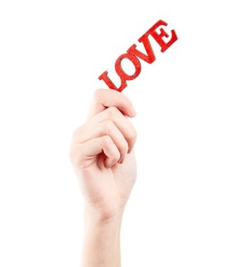 Kadın eli beyaz arka planda izole edilmiş. Beyaz kadının elinde semboller ve jestler var. Tahta kırmızı yazıt aşkı. Aşk