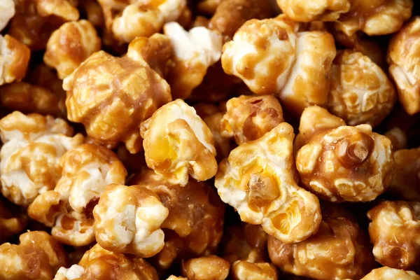 caramel pop corn background. Golden caramel popcorn close up. Background of popcorn. Snacks and food for a movie