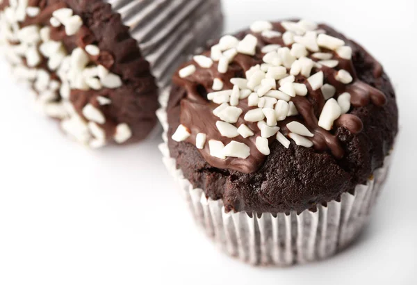 Tasty chocolate cupcakes on white background. Chocolate caramel cupcake and butterscotch syrup. Chocolate cupcake isolated on white.