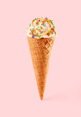 Pembe arka planda Waffle Cone 'da beyaz dondurma topu. Waffle külahında meyveli dondurma.