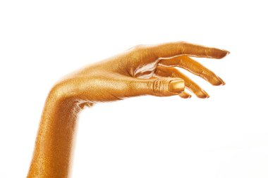 Altın boyalı eller. Altın parmaklar. Kadın eli beyaz arka planda izole edilmiş. Beyaz kadının elinde semboller ve jestler var..