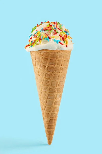 white ice cream ball in a Waffle Cone on a blue Background. Fruit ice cream in a waffle cone.