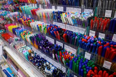 Kalemler dükkanda, ofis malzemeleri ve kırtasiye malzemeleri. Kalemler kırtasiye malzemeleri satıyor. Sanat, atölye, zanaat, yaratıcılık konsepti. Bir sürü kalem yığını. Kırtasiyede farklı kalem ve kırtasiye malzemesi olan raflar.
