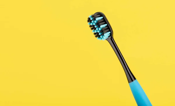 Blue Black Toothbrush Yellow Background Oral Health Personal Hygiene — Stock Photo, Image