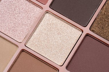 Cosmetics. Eyeshadow palette featuring a variety of colorful matte and shimmer shades. Essential cosmetic product for professional makeup artists, beauty tutorials, and fashion industry themes