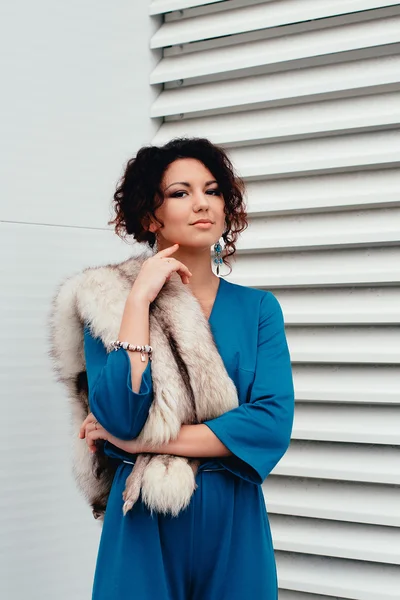 Beautiful curly-haired woman in a long dress