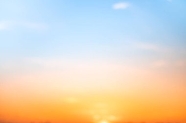 Sunset or sunrise sky with a vibrant gradient of orange, gold, and soft blue. Clear atmosphere with wispy clouds. Peaceful, natural light background. hope, freedom, new day and inspirational Concepts