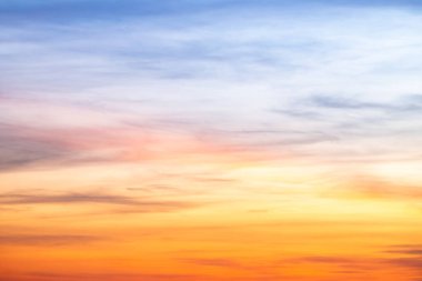 Sunset or sunrise sky with a vibrant gradient of orange, gold, and soft blue. Clear atmosphere with wispy clouds. Peaceful, natural light background. hope, freedom, new day and inspirational Concepts