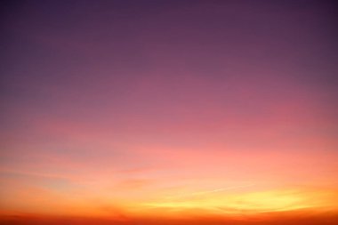Sunset or sunrise sky with a vibrant gradient of orange, gold, and soft blue. Clear atmosphere with wispy clouds. Peaceful, natural light background. hope, freedom, new day and inspirational Concepts