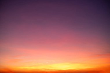 Sunset or sunrise sky with a vibrant gradient of orange, gold, and soft blue. Clear atmosphere with wispy clouds. Peaceful, natural light background. hope, freedom, new day and inspirational Concepts