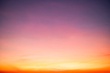 Sunset or sunrise sky with a vibrant gradient of orange, gold, and soft blue. Clear atmosphere with wispy clouds. Peaceful, natural light background. hope, freedom, new day and inspirational Concepts