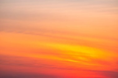 Sunset or sunrise sky with a vibrant gradient of orange, gold, and soft blue. Clear atmosphere with wispy clouds. Peaceful, natural light background. hope, freedom, new day and inspirational Concepts