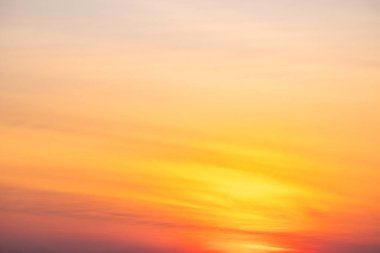 Sunset or sunrise sky with a vibrant gradient of orange, gold, and soft blue. Clear atmosphere with wispy clouds. Peaceful, natural light background. hope, freedom, new day and inspirational Concepts
