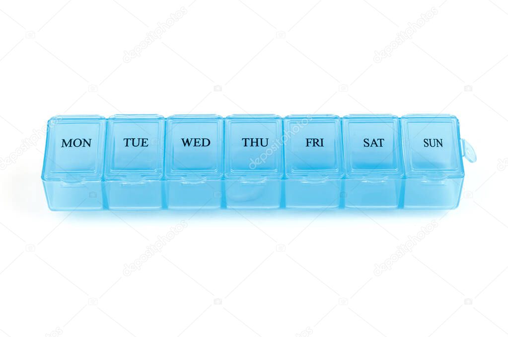 Blue plastic organizer, for pills isolated on white background. Close-up on compartments pill case with clip lids medicine . Daily vitamins and supplements dosage routine concept.