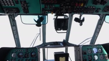 Helicopter cabin. Mi-8. The cockpit. View from the cab. Everything is white outside the window. Instrument panel.