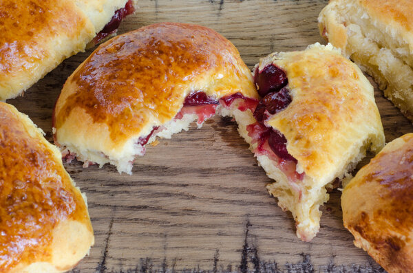 Homemade cakes with cherries on wooden table in rustic style. Organic food.