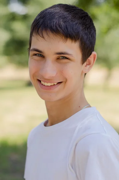 Close up portrait of a young smiling cute teenager with blue eye. — Stock Photo, Image