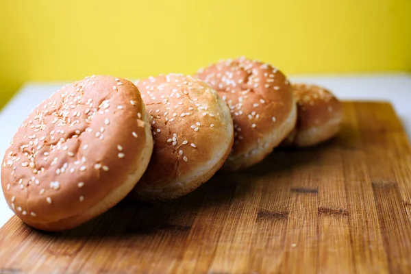 The burger buns on wooden background — Stock Photo, Image