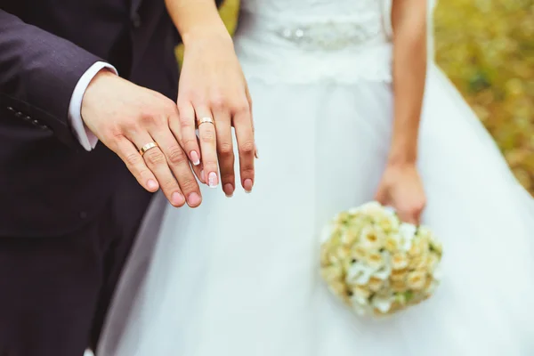 Mãos de casal recém-casados com anéis de casamento — Fotografia de Stock