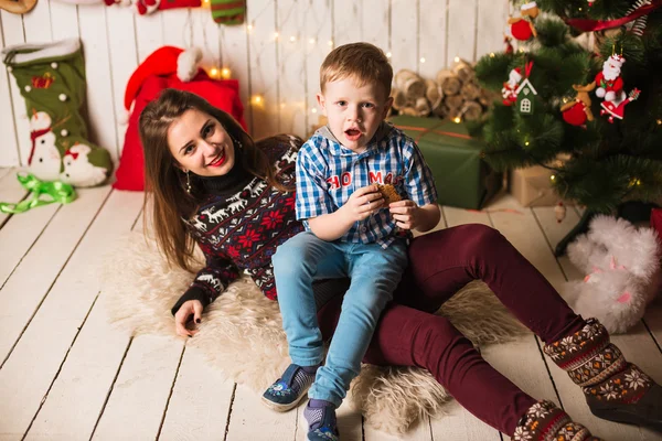 Schwester und kleiner Bruder vor dem Weihnachtsbaum — Stockfoto