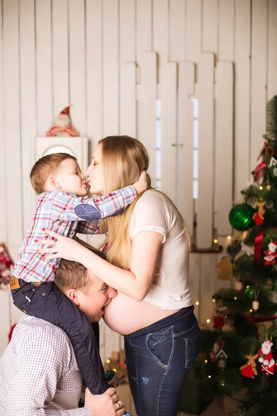 Young pregnant mother, father and small son celebrating Christmas at home — Stock Photo, Image