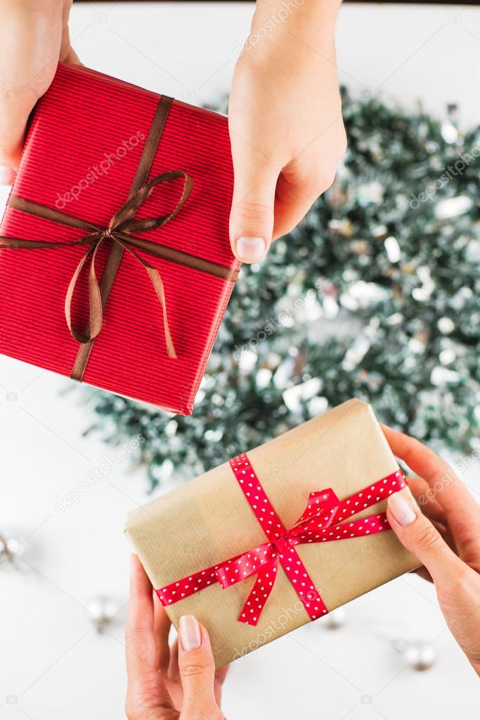 Closeup of hands giving gifts to each other