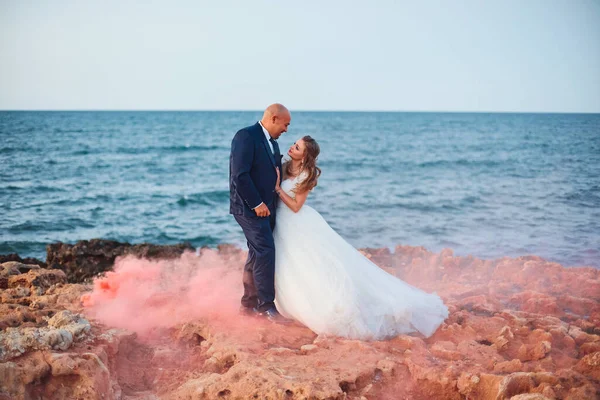 Bruid Knuffelt Bruidegom Glimlachend Achtergrond Van Rode Rook Kust Rotsen — Stockfoto