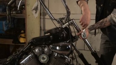 Motorcu parçaları motosiklet garajda toplar