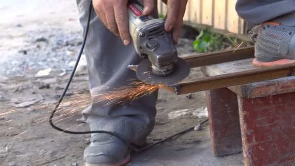 Man grinding motorcycle parts in the garage — Stock Video