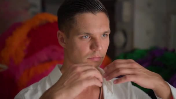 A táncos beállítja a fehér inggallért a tükör előtt az öltözőben — Stock videók