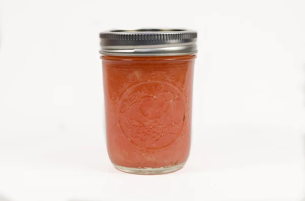Grapefruit in Glaskanister isoliert auf weißem Hintergrund konservieren — Stockfoto