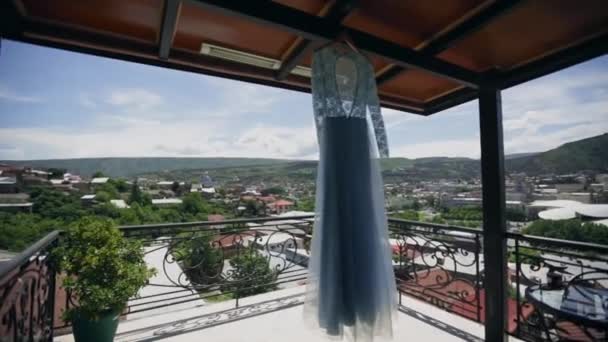 Beautiful dress hanging on the veranda — Stock Video